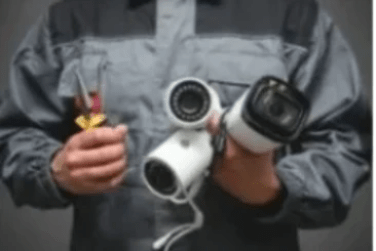 Licensed technician with tools in his hand servicing CCTV  cameras