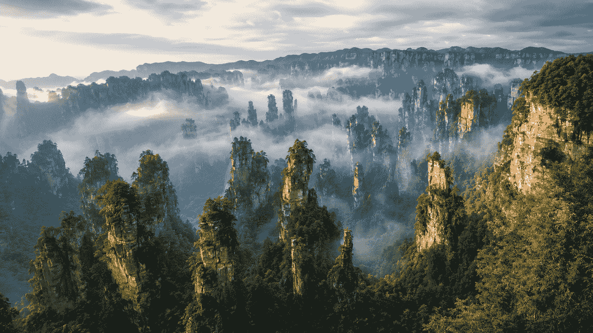 Sandstone pillars rising through morning mist in Zhangjiajie National Forest Park Sandstone pillars rising through morning mist in Zhangjiajie National Forest Park