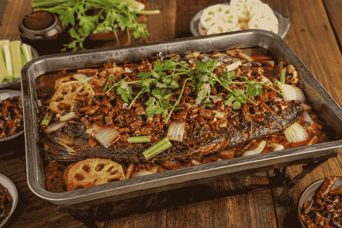 Chongqing grilled whole fish served with chilies, lotus root, onions and fresh herbs Chongqing grilled whole fish served with chilies, lotus root, onions and fresh herbs
