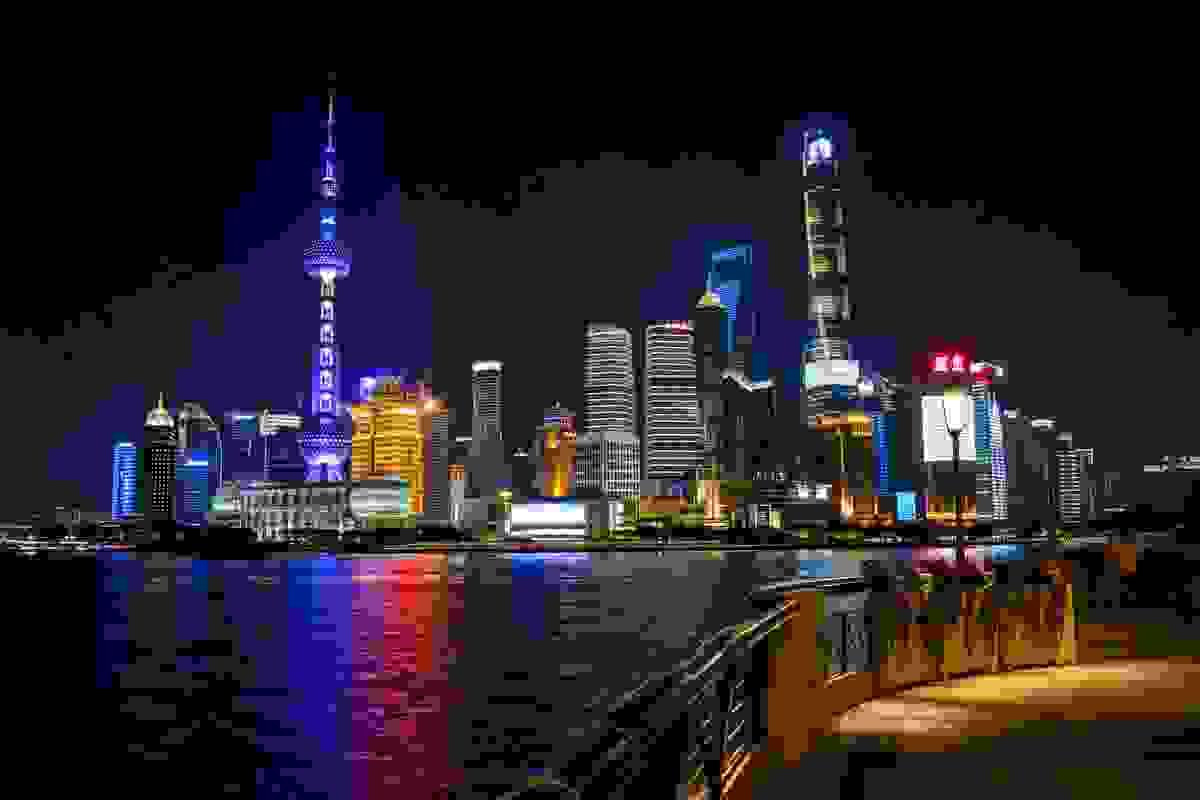 Nighttime panorama of the Bund waterfront, Lujiazui skyline with illuminated Oriental Pearl Tower and skyscrapers reflecting in the Huangpu River under a clear night sky. Nighttime panorama of the Bund waterfront, Lujiazui skyline with illuminated Oriental Pearl Tower and skyscrapers reflecting in the Huangpu River under a clear night sky.