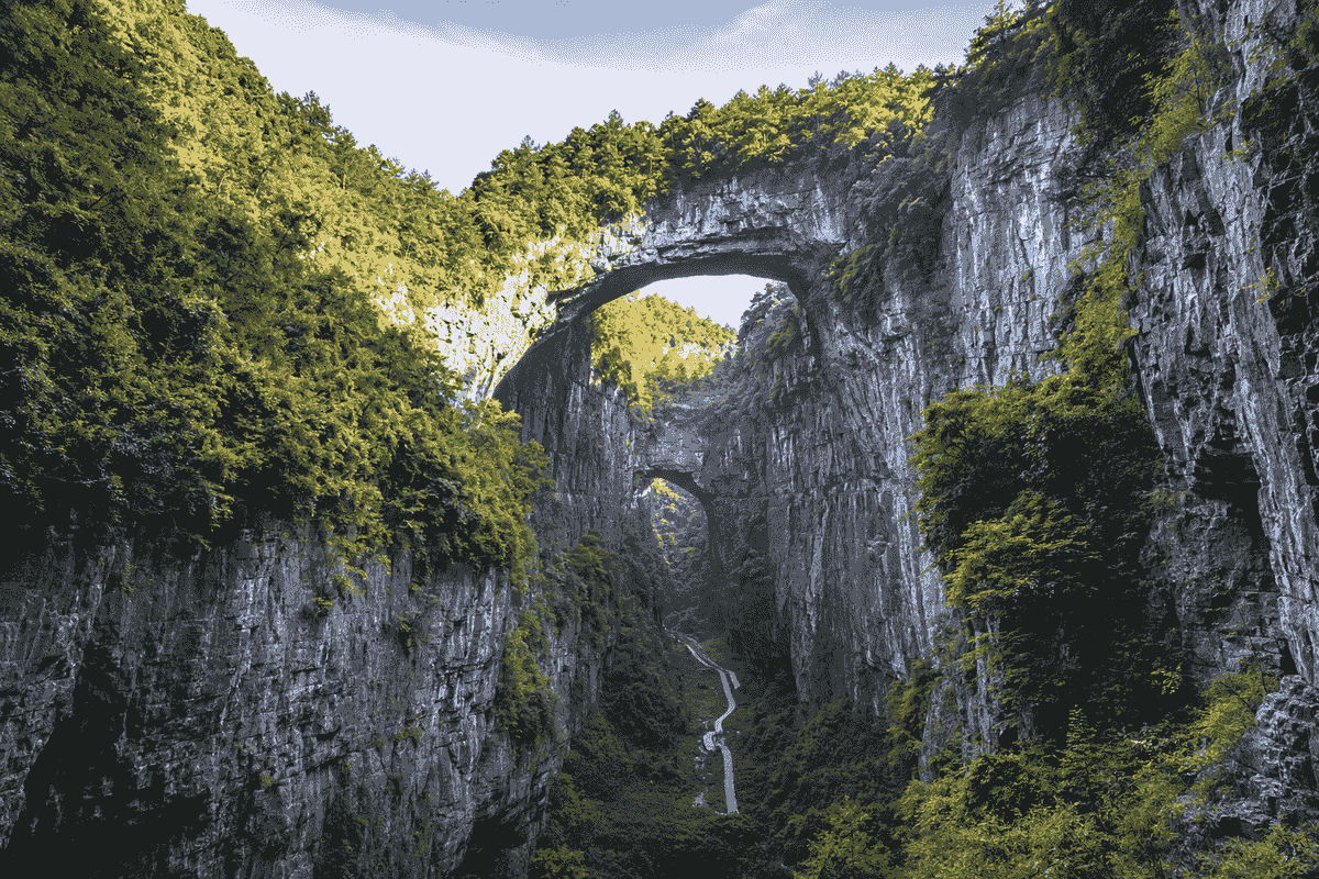Natural limestone bridges and forested cliffs at Wulong Karst near Chongqing, China Natural limestone bridges and forested cliffs at Wulong Karst near Chongqing, China