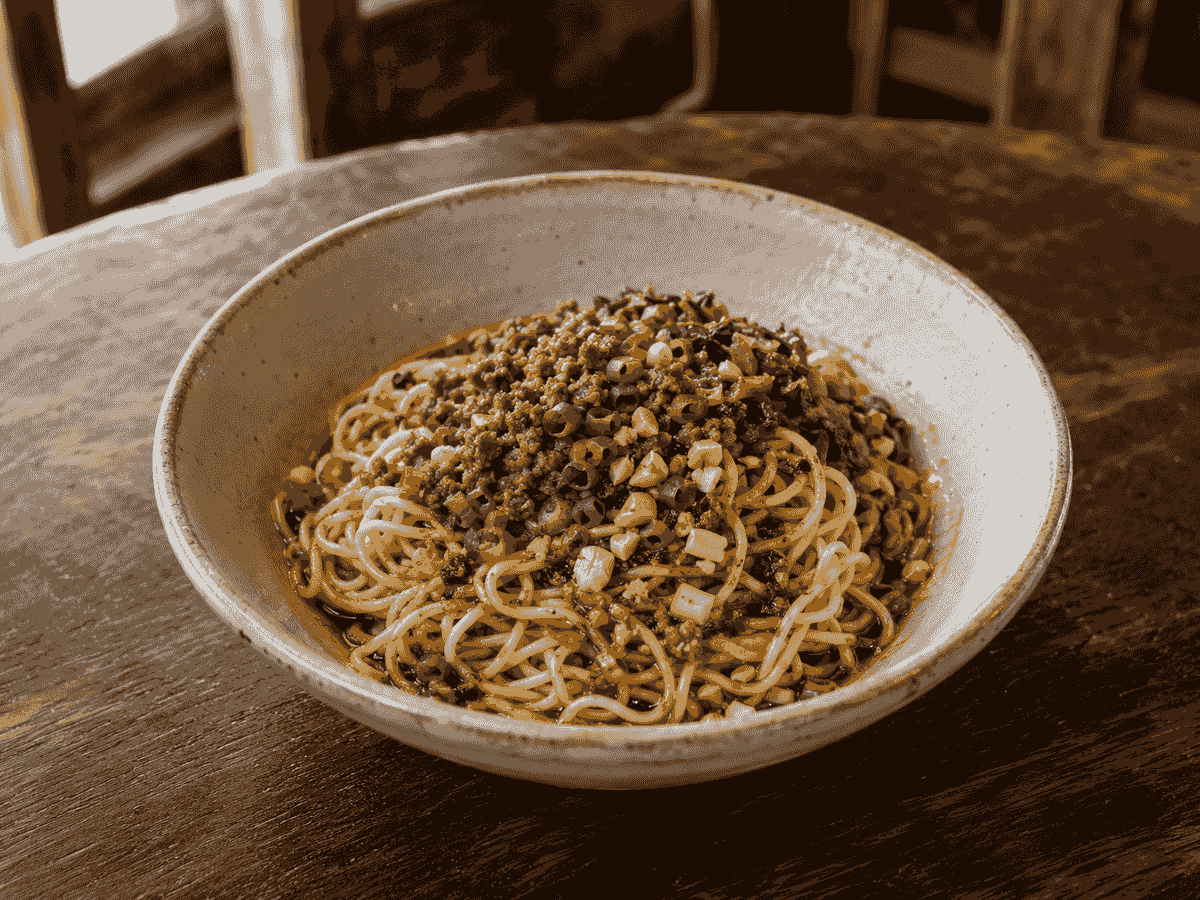 Traditional Chengdu dan dan noodles with minced pork, preserved vegetables and chili sauce Traditional Chengdu dan dan noodles with minced pork, preserved vegetables and chili sauce
