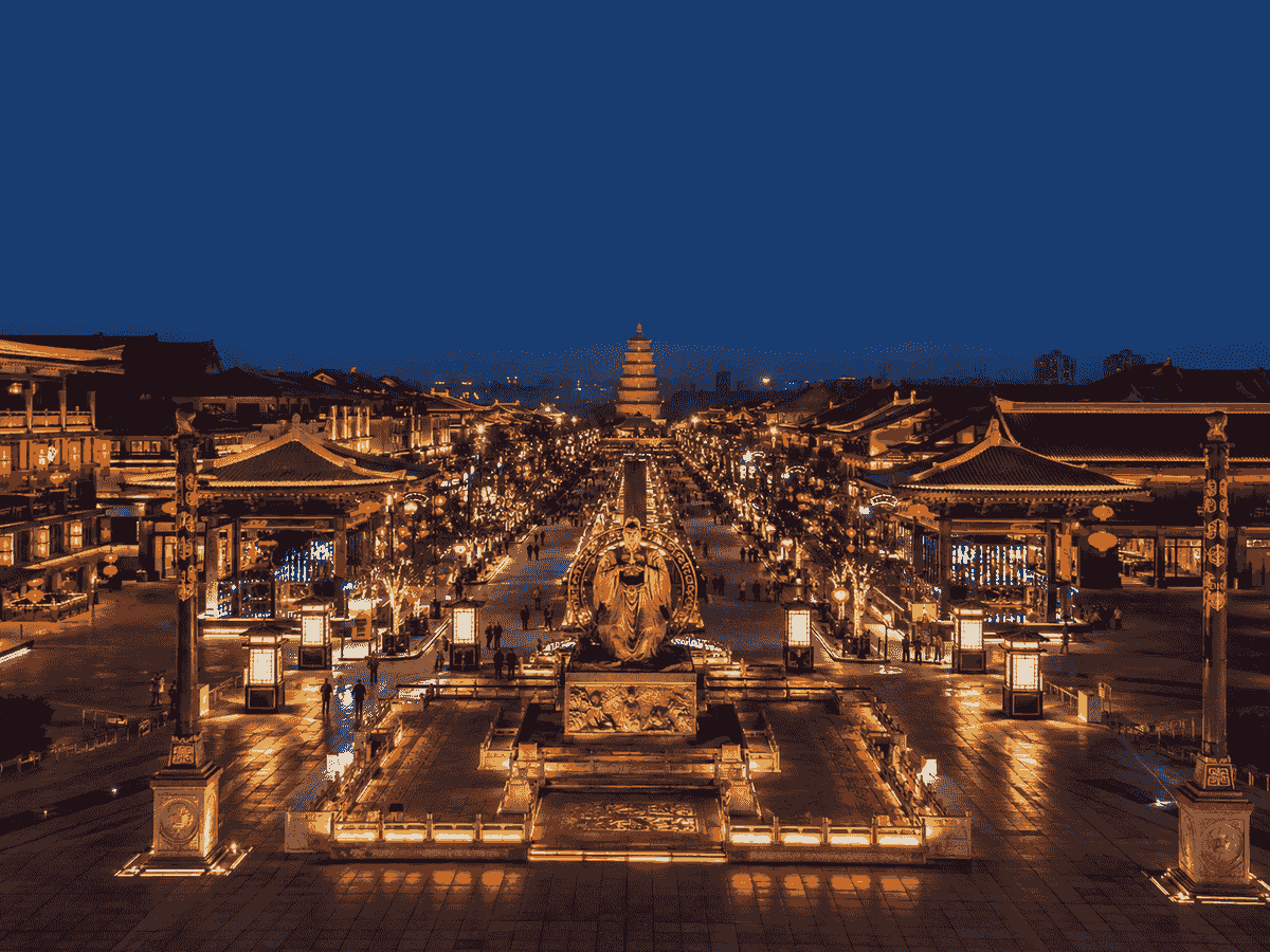 Grand Tang Mall in Xi’an illuminated at night with Tang-inspired buildings, lanterns and sculptures. Grand Tang Mall in Xi’an illuminated at night with Tang-inspired buildings, lanterns and sculptures.