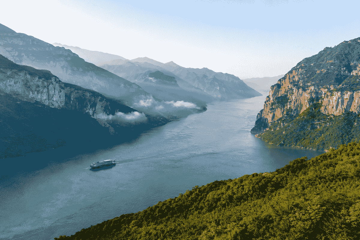 Cruise ship sailing through the mountainous Three Gorges on the Yangtze River in China Cruise ship sailing through the mountainous Three Gorges on the Yangtze River in China