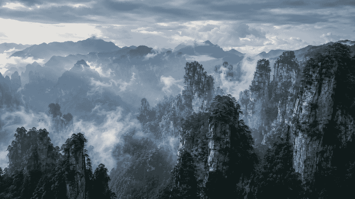 Clouds drifting between sandstone peaks at Tianzi Mountain in Zhangjiajie Clouds drifting between sandstone peaks at Tianzi Mountain in Zhangjiajie