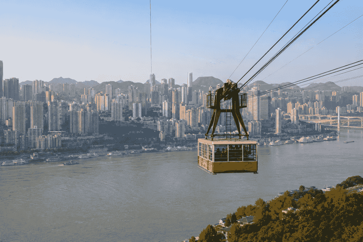 Yangtze River cable car crossing above the river with the Chongqing skyline behind it Yangtze River cable car crossing above the river with the Chongqing skyline behind it