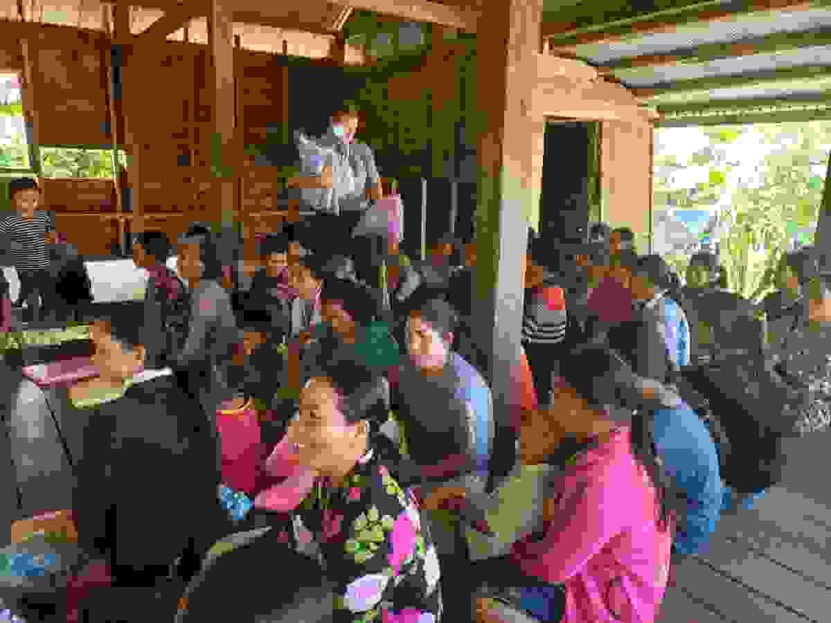 Mark distributing mosquito nets to Cambodian villagers