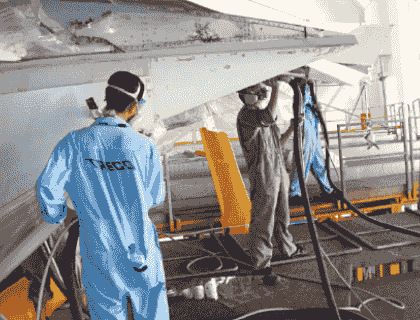 Technician performing maintenance on an aluminum dust collector