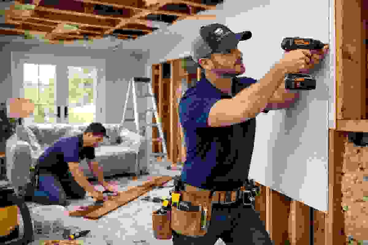 Contractors renovating interior living space after water damage with drywall and ceiling repairs in Austin, Texas Contractors renovating interior living space after water damage with drywall and ceiling repairs in Austin, Texas