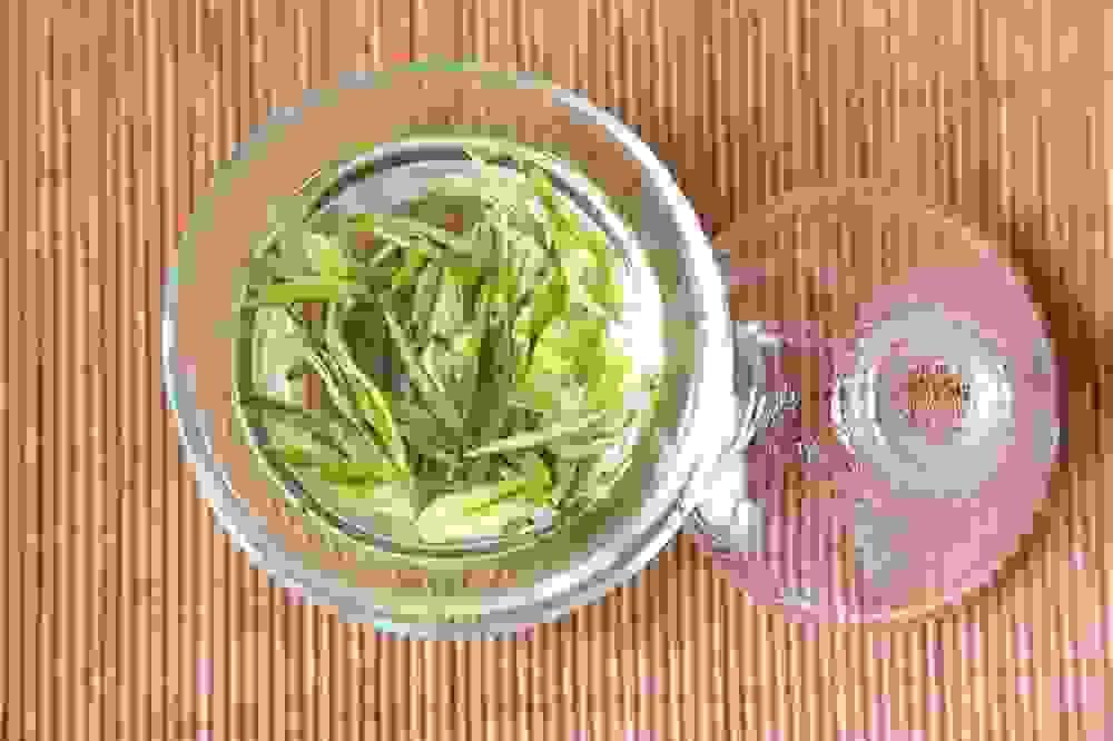 1. Experience the exquisite taste of Longjing Tea with our premium collection. Discover the true essence of this renowned Chinese green tea.  2. Elevate your teadrinking experience with Longjing Tea, handpicked and expertly crafted to perfection. Indulge in a cup of pure luxury.  3. Immerse yourself in the rich history and delicate flavors of Longjing Tea. Savor every sip of this finest green tea variety straight from China.  4. Unlock the secrets of Longjing Tea's unique aroma and flavor profile. Delight your senses and nourish your body with each refreshing brew.  5. Delight in the pure and refreshing taste of Longjing Tea, a true masterpiece of Chinese tea culture. Explore a new world of tea perfection with every cup.