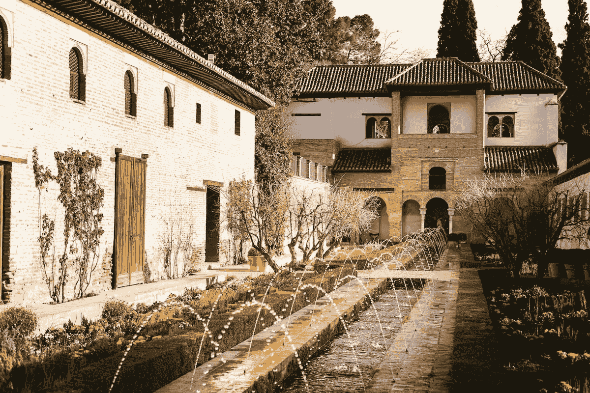 Andalusian courtyard with fountain reflecting Islamic architectural heritage in Málaga Andalusian courtyard with fountain reflecting Islamic architectural heritage in Málaga