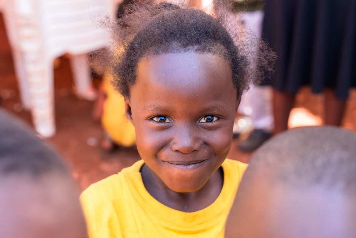 A child in the 22STARS community smiling at the camera
