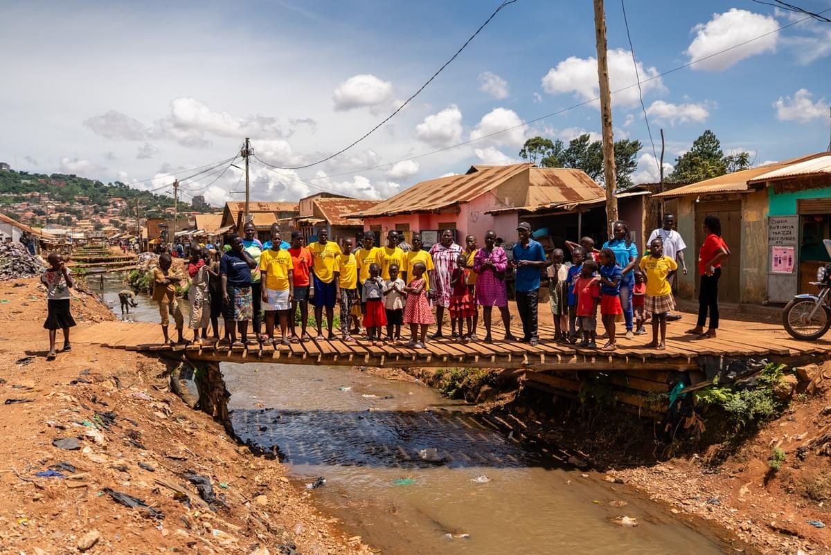 Children standing together on a bridge in their community in Uganda