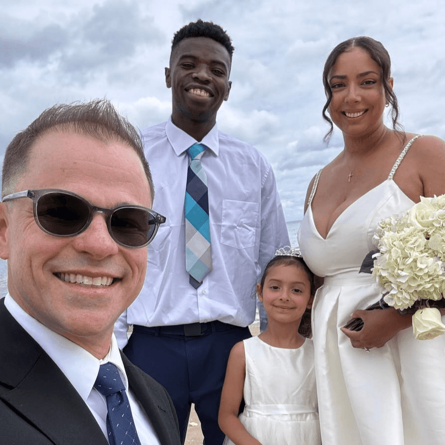 Wisconsin officiant Schwa Potter with newlyweds and flower girl at beach ceremony Wisconsin officiant Schwa Potter with newlyweds and flower girl at beach ceremony