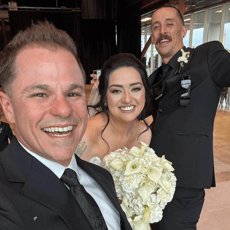 Milwaukee wedding officiant Schwa Potter with bride and groom at indoor venue Milwaukee wedding officiant Schwa Potter with bride and groom at indoor venue