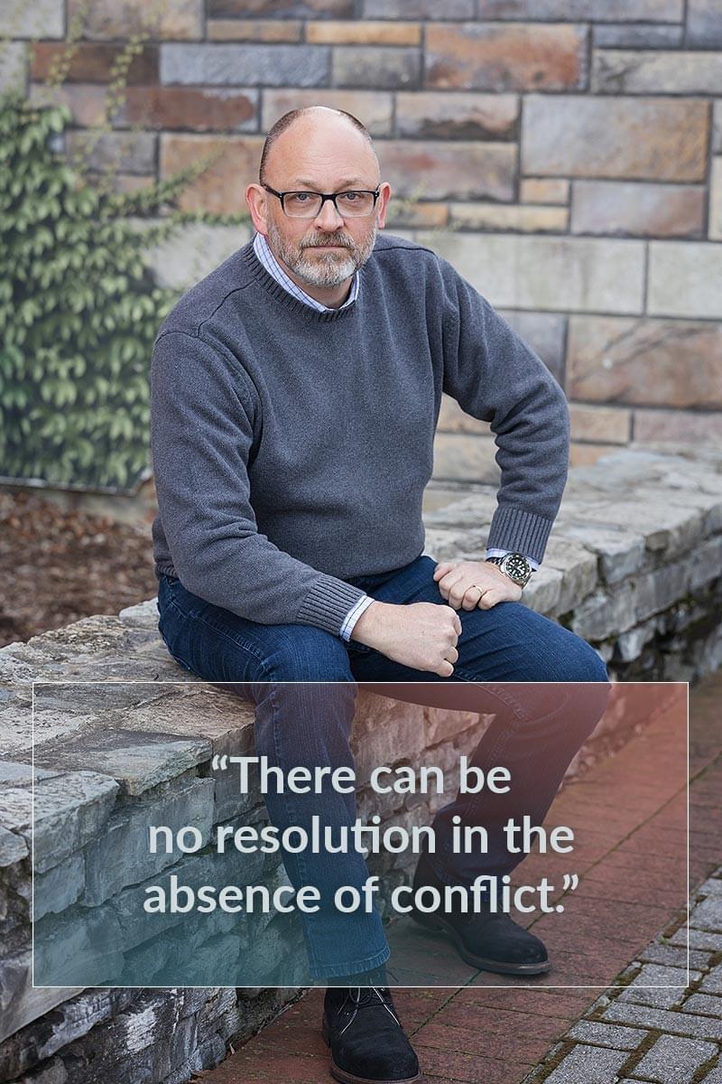 Photo of Bob Stoneking with quote: "There can be no resolution in the absence of conflict."