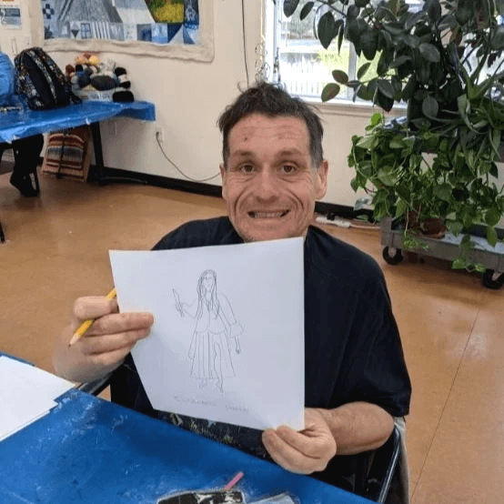 Artist Kris Askew displaying art.