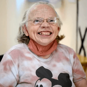 Artist Beverly Powell smiling.