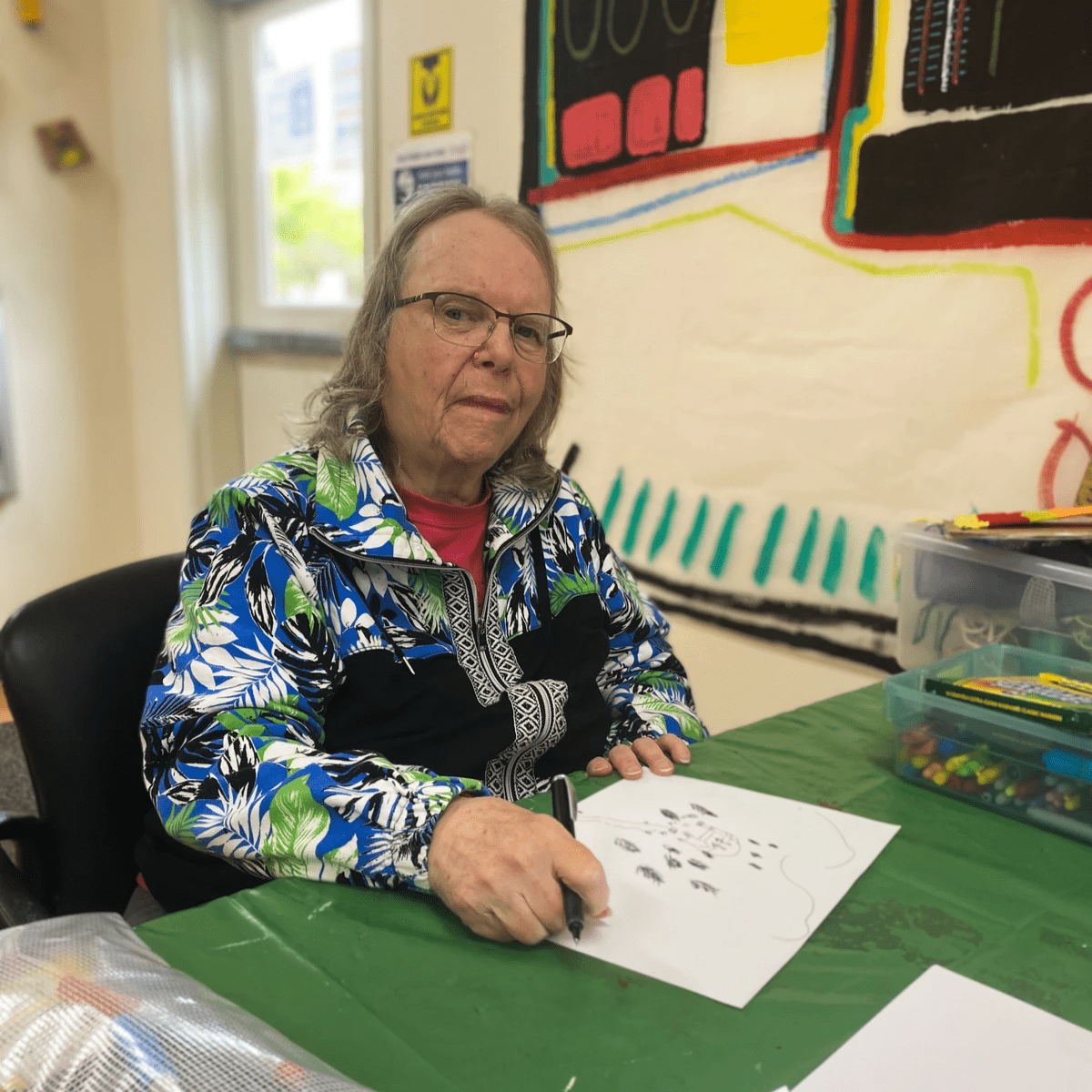 Artist Linda Bach working on art.
