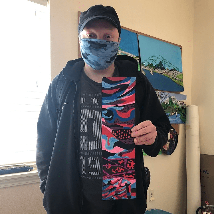 Artist Matthew Brewster holding a piece