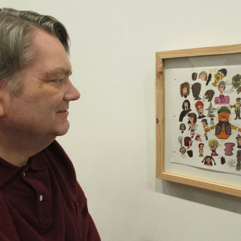 Artist Kirt Fisk displaying art.