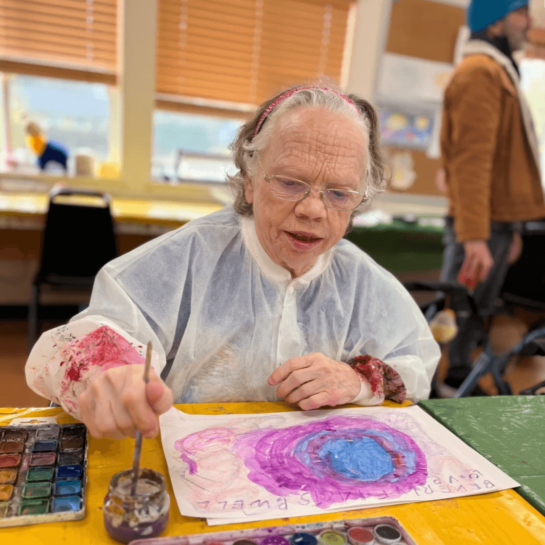 Artist Beverly Powell smiling.