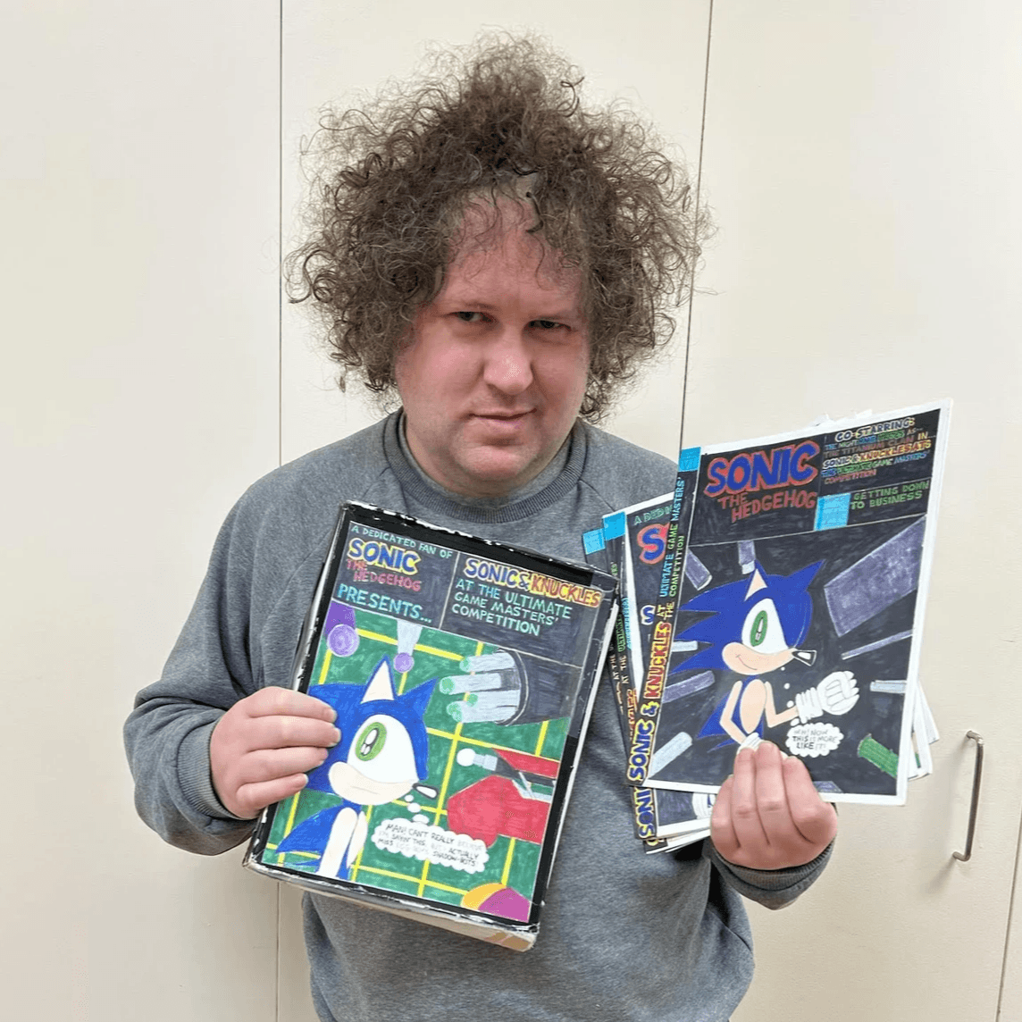 Artist Patrick Hackleman displaying art.