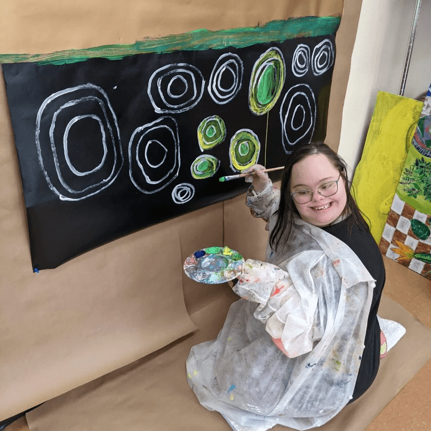 Artist Susan Woods displaying art.