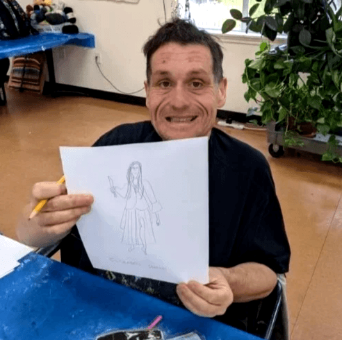 Artist Kris Askew displaying art.