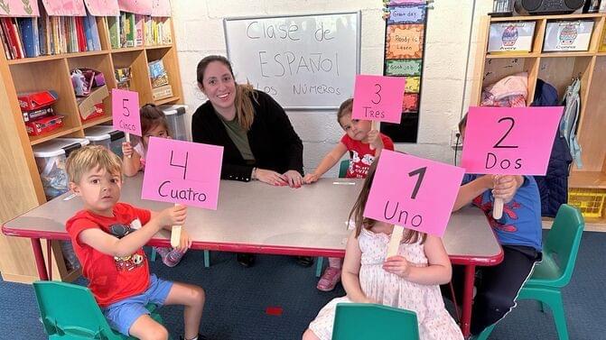 Children learning Spanish numbers with teacher at Ballston Children’s Center preschool program in Arlington County, VA.