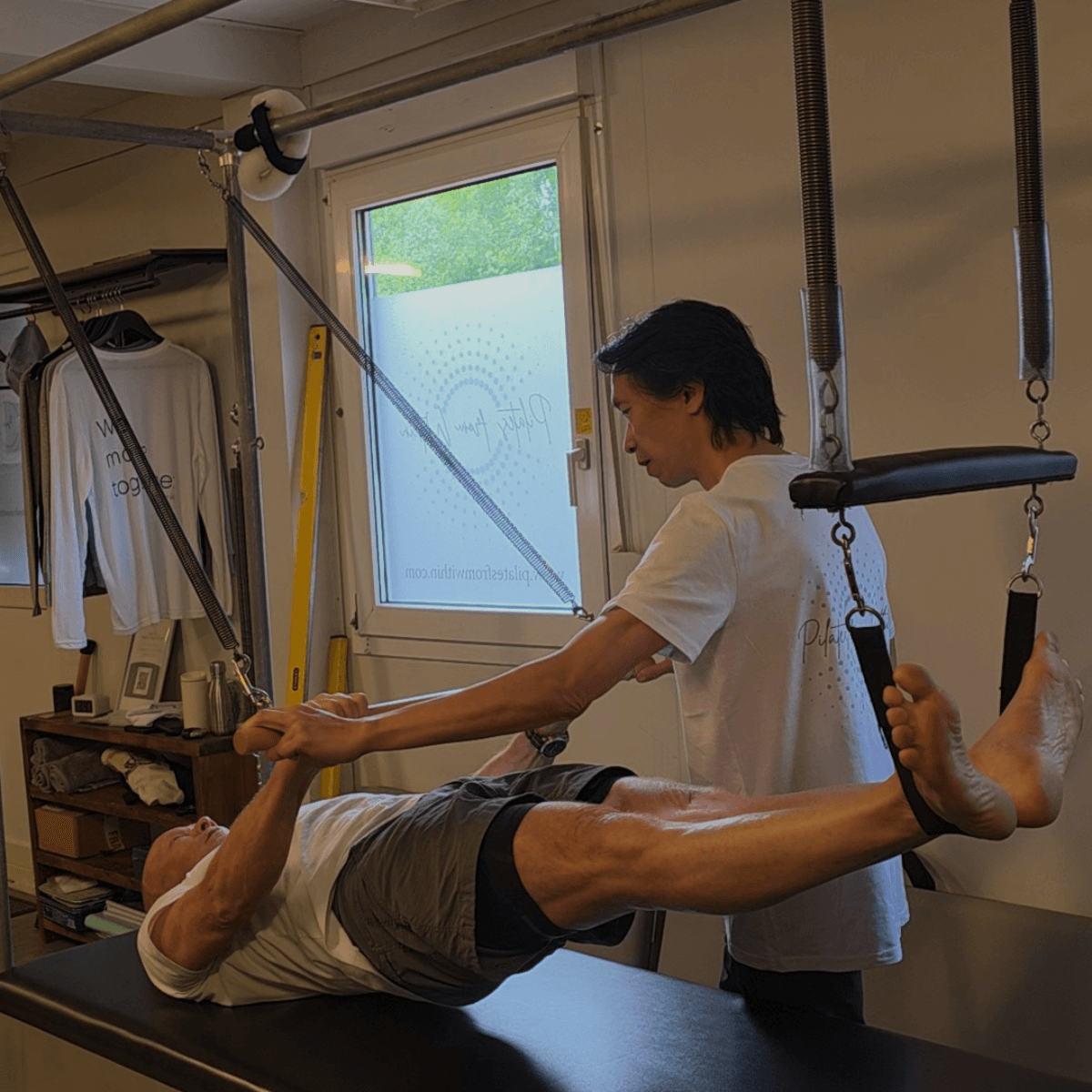 Tim assisting client with Pilates technique and posture in Haslemere studio