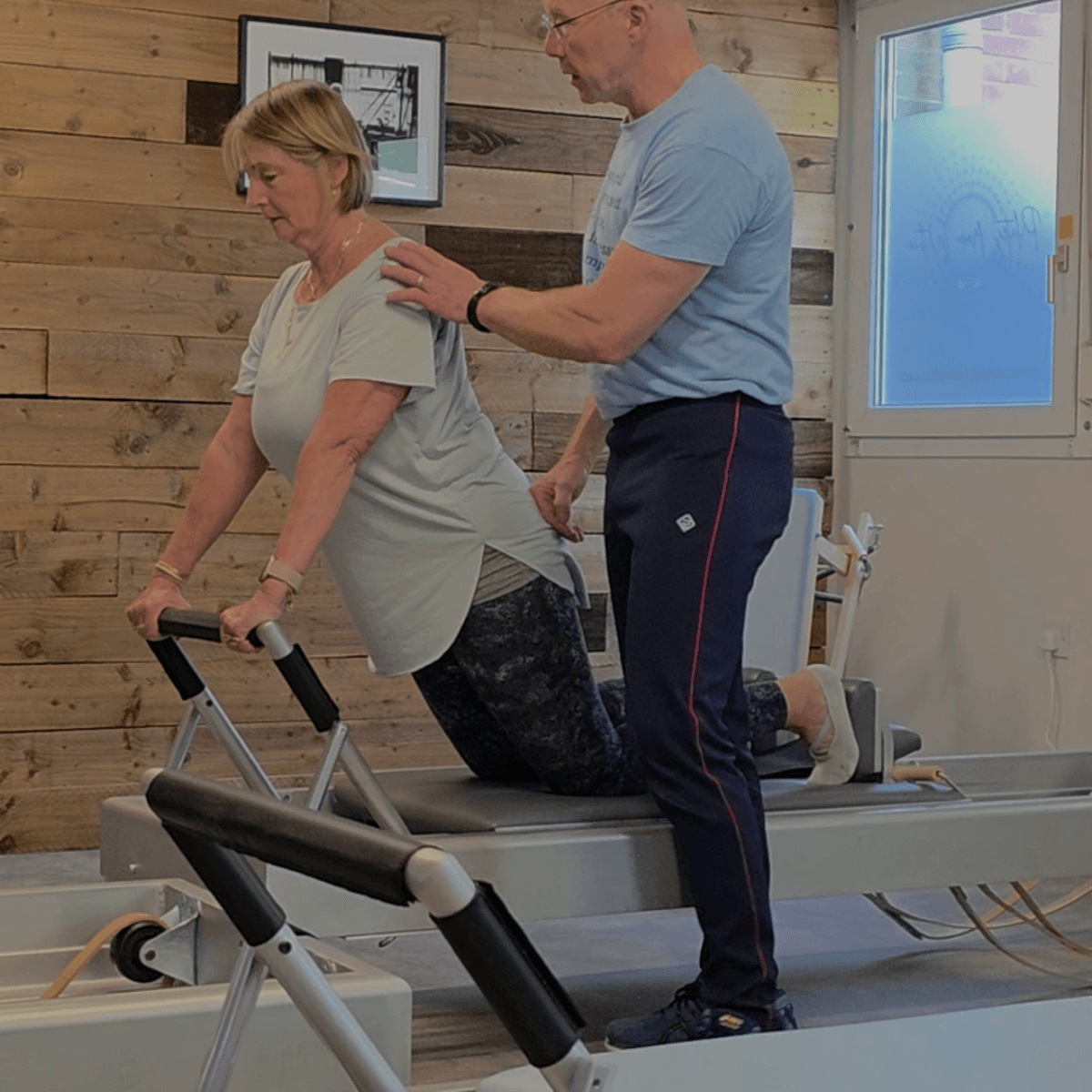 Tim assisting client with Pilates technique and posture in Haslemere studio Tim assisting client with Pilates technique and posture in Haslemere studio