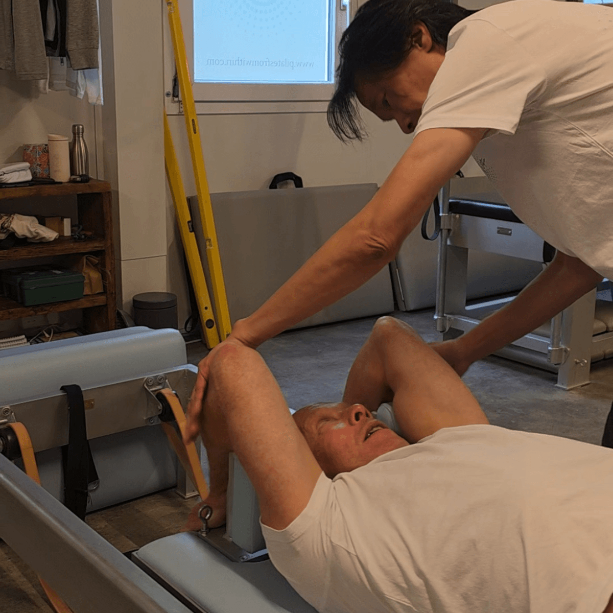 Tim guiding group reformer Pilates class at Pilates From Within Haslemere studio