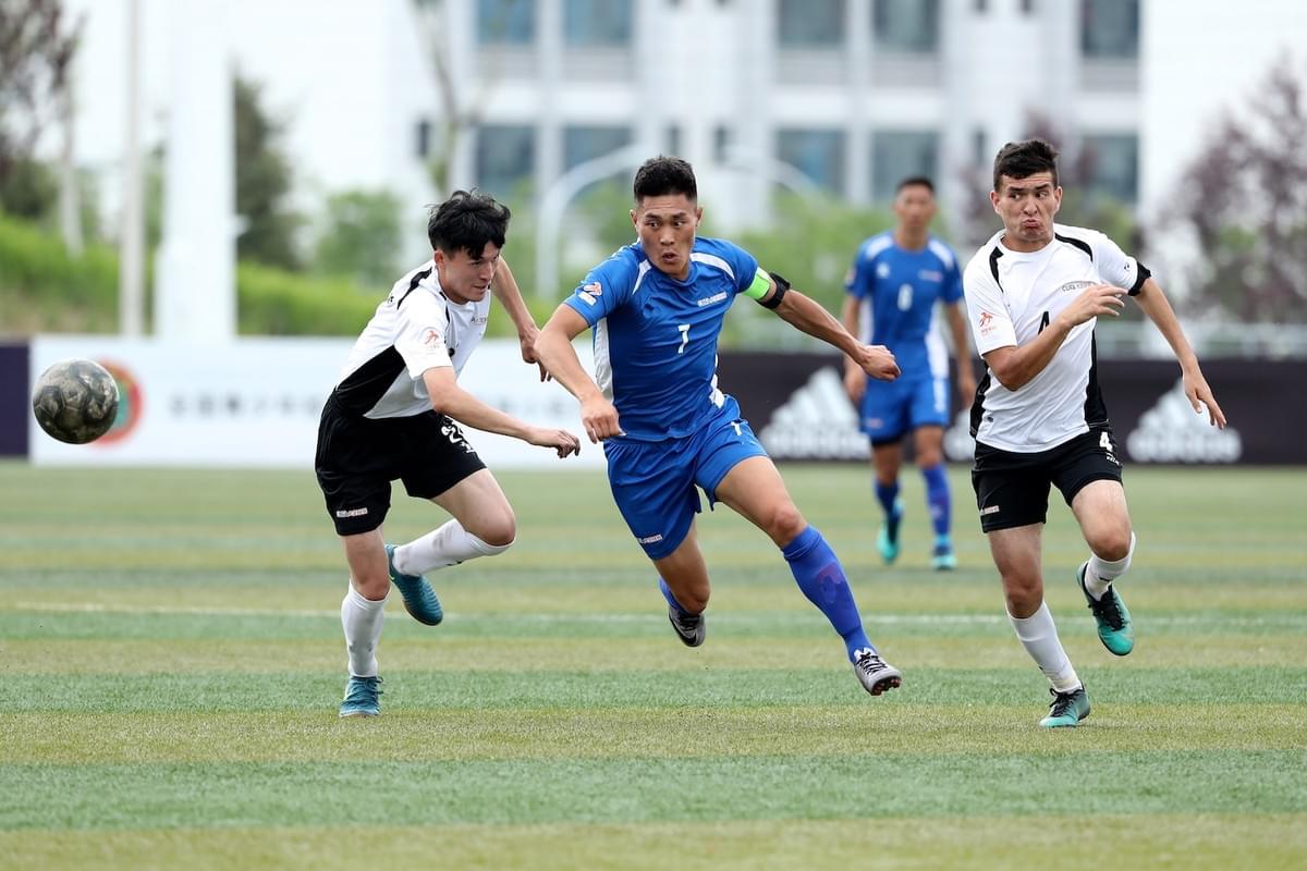 Players competing for the ball in a CUFA (China University Football Association) match using the INSAIT KS system, featuring wearable player trackers and the connected smart ball for professional data collection.