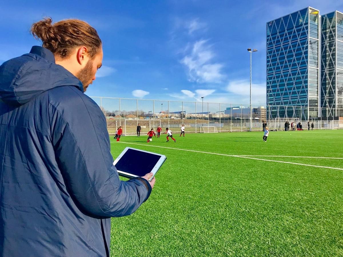 Professional coach tracking player performance with Gengee technology, embodying our long-term partnership ethos to empower football clubs at all levels.