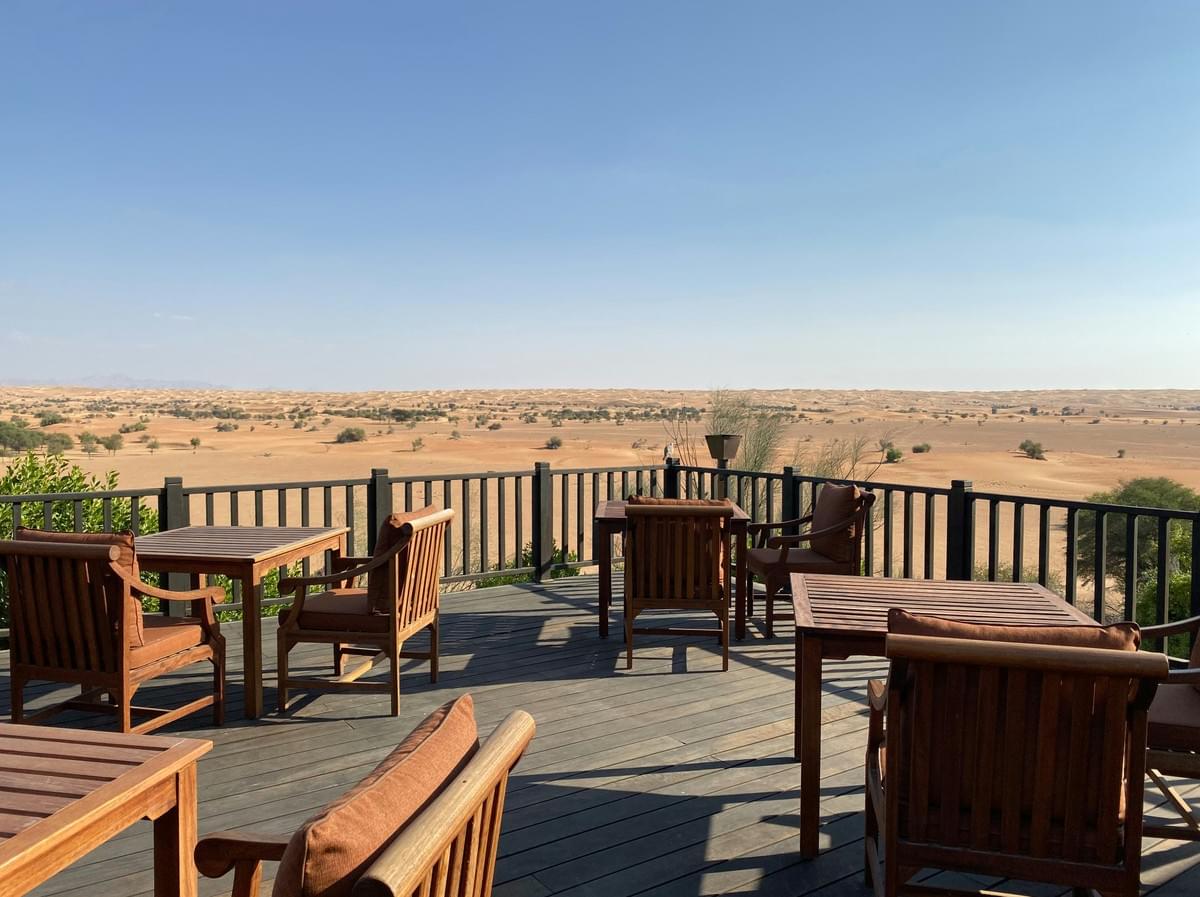Commercial wood deck with railings and multi-table seating overlooking desert landscape. Custom commercial or residential deck builder MIdland
