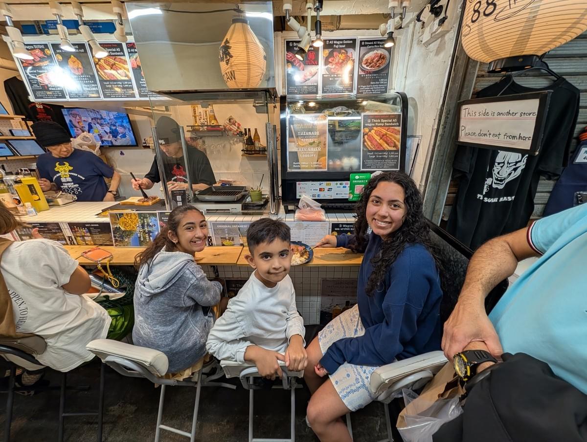 FamTripping Japan trip with the Devani and Ali family eating at Tsukiji Outer Market in Tokyo in summer 2026.