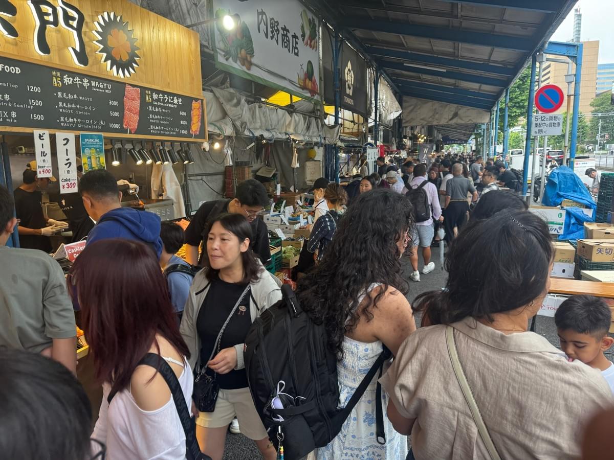 FamTripping Japan trip with the Devani and Ali family trying Japanese market food at Tsukiji Outer Market in Tokyo in summer 2026.