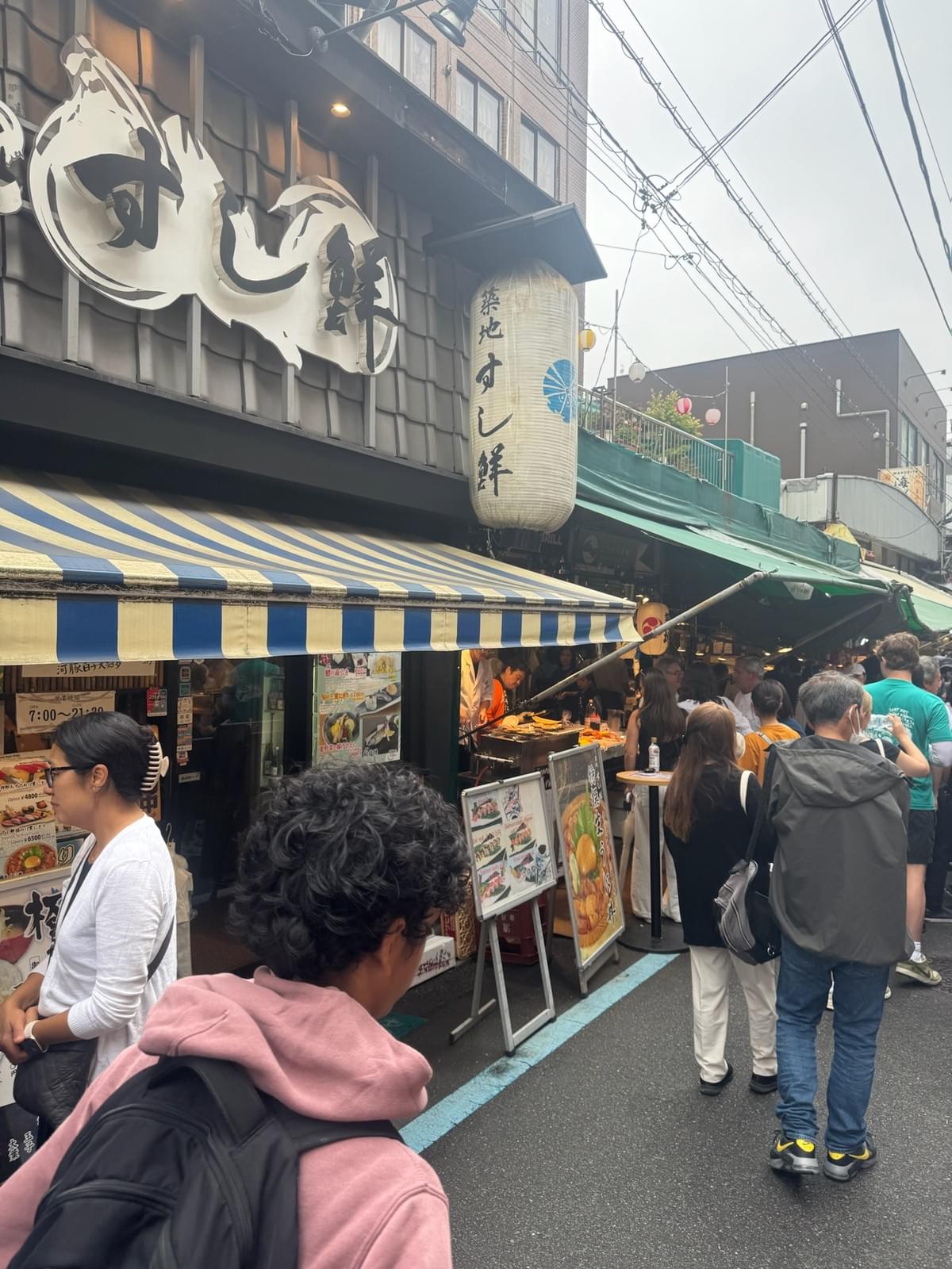 FamTripping Japan trip with the Devani and Ali family enjoying food at Tsukiji Outer Market in Tokyo in summer 2026.