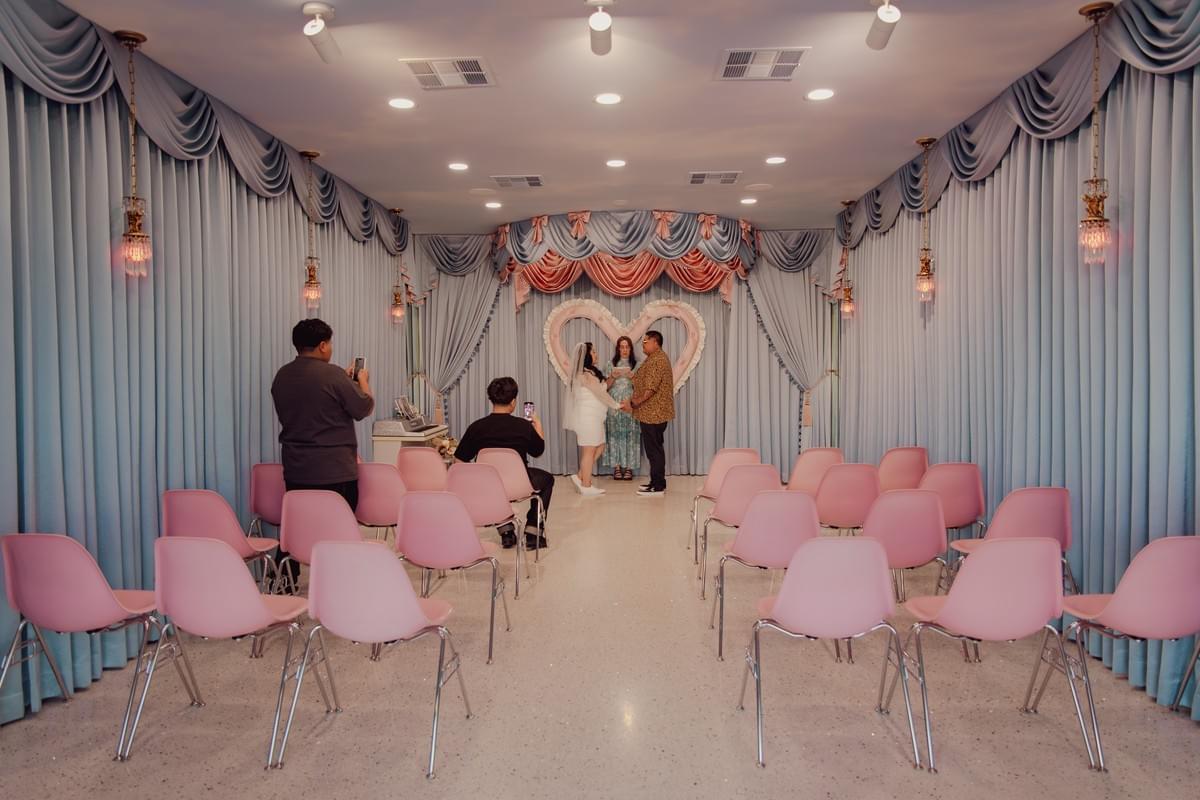Candid moment of a couple during their wedding ceremony at the quirky Sure Thing chapel in Las Vegas, Nevada.