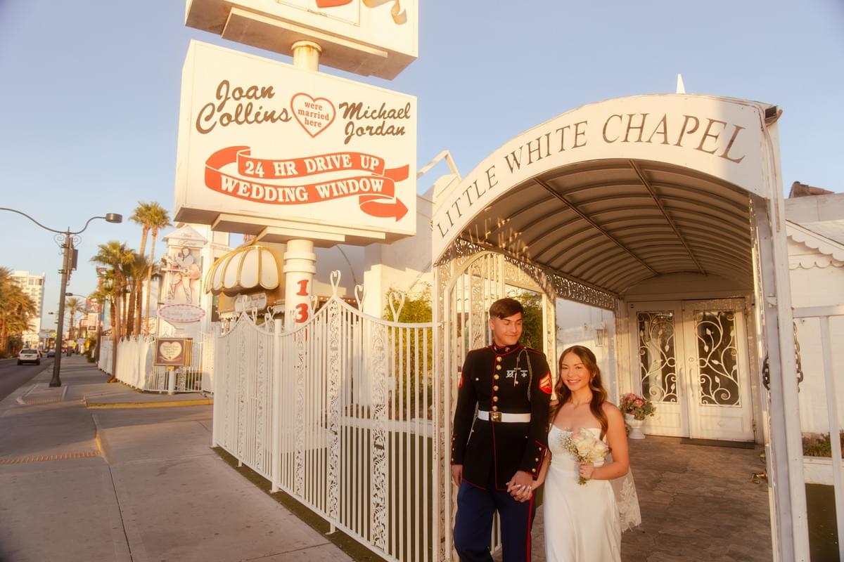 Newlyweds happily walking out of the Little White Wedding Chapel in Las Vegas after saying "I do," captured by Falling Rocks Photography.