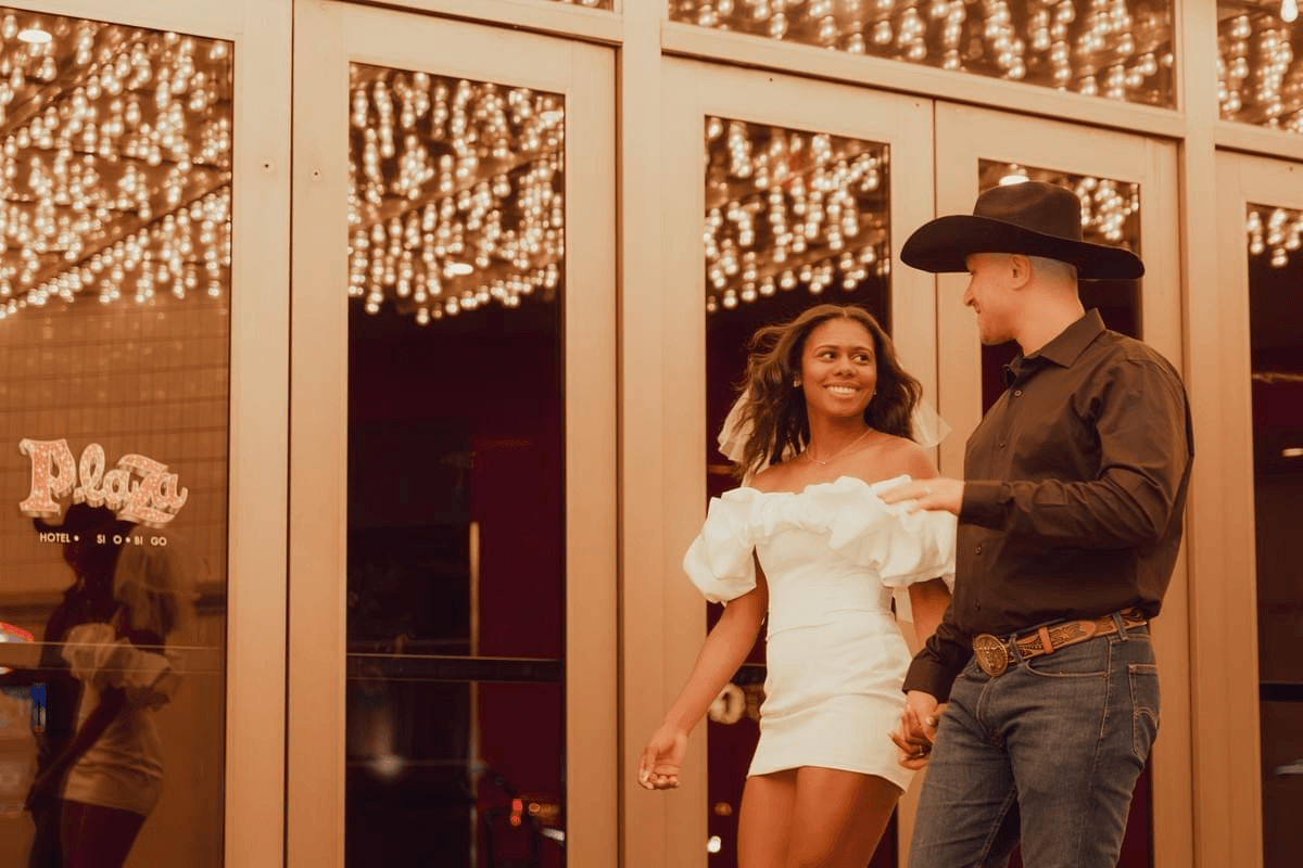 couple walking downtown Fremont Street with neon lights