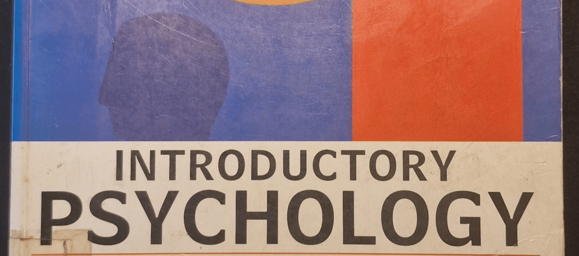Cover of the book “Introductory Psychology” by Tony Malim and Ann Birch, featuring abstract geometric artwork with an orange ring, red circle, blue shape, and white cloud‑like form on a blue background; worn paperback textbook. Cover of the book “Introductory Psychology” by Tony Malim and Ann Birch, featuring abstract geometric artwork with an orange ring, red circle, blue shape, and white cloud‑like form on a blue background; worn paperback textbook.