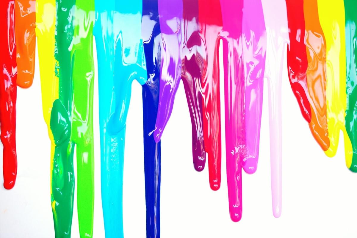 Glossy paint drips in a rainbow spectrum—red, orange, yellow, green, turquoise, cyan, blue, indigo, violet, pink, and white—flow vertically down a white background. The thick, blended colors create a dynamic, textured display that evokes creativity and artistic expression. Glossy paint drips in a rainbow spectrum—red, orange, yellow, green, turquoise, cyan, blue, indigo, violet, pink, and white—flow vertically down a white background. The thick, blended colors create a dynamic, textured display that evokes creativity and artistic expression.