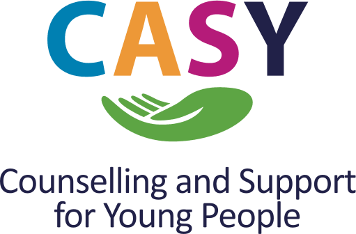 A colorful logo for CASY, an organization focused on counseling and support for young people. The acronym “CASY” is displayed in large, playful letters: “C” in blue, “A” in orange, “S” in pink, and “Y” in dark blue. Beneath the acronym is a green graphic of an open hand, symbolizing care, support, and approachability. Below the hand, the full name “Counselling and Support for Young People” appears in smaller, dark blue uppercase text. The design combines warmth and professionalism, reflecting CASY’s mission to provide accessible mental health support for youth