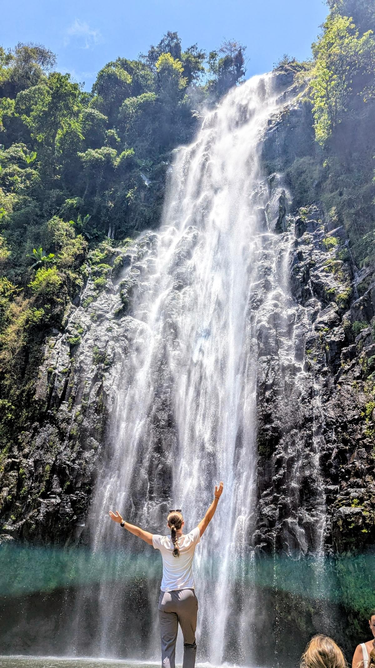 Materuni Waterfalls near Mount Kilimanjaro surrounded by tropical forest and lush greenery in Tanzania.