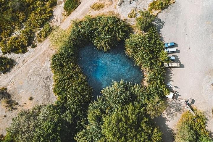 Aerial view of Chemka Hot Springs oasis surrounded by palm trees, a popular Moshi day trip destination in Tanzania. Aerial view of Chemka Hot Springs oasis surrounded by palm trees, a popular Moshi day trip destination in Tanzania.