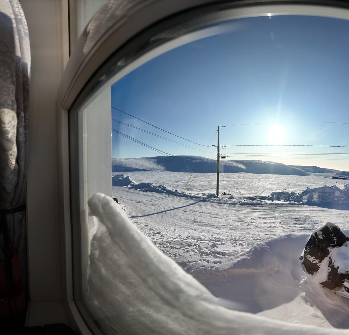 The view from a snow filled window in Kangirsuk, Arctic