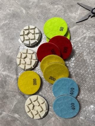 100mm resin polishing pads in 50, 100, 200 and 400 grit packed for marble and terrazzo wet polishing.
