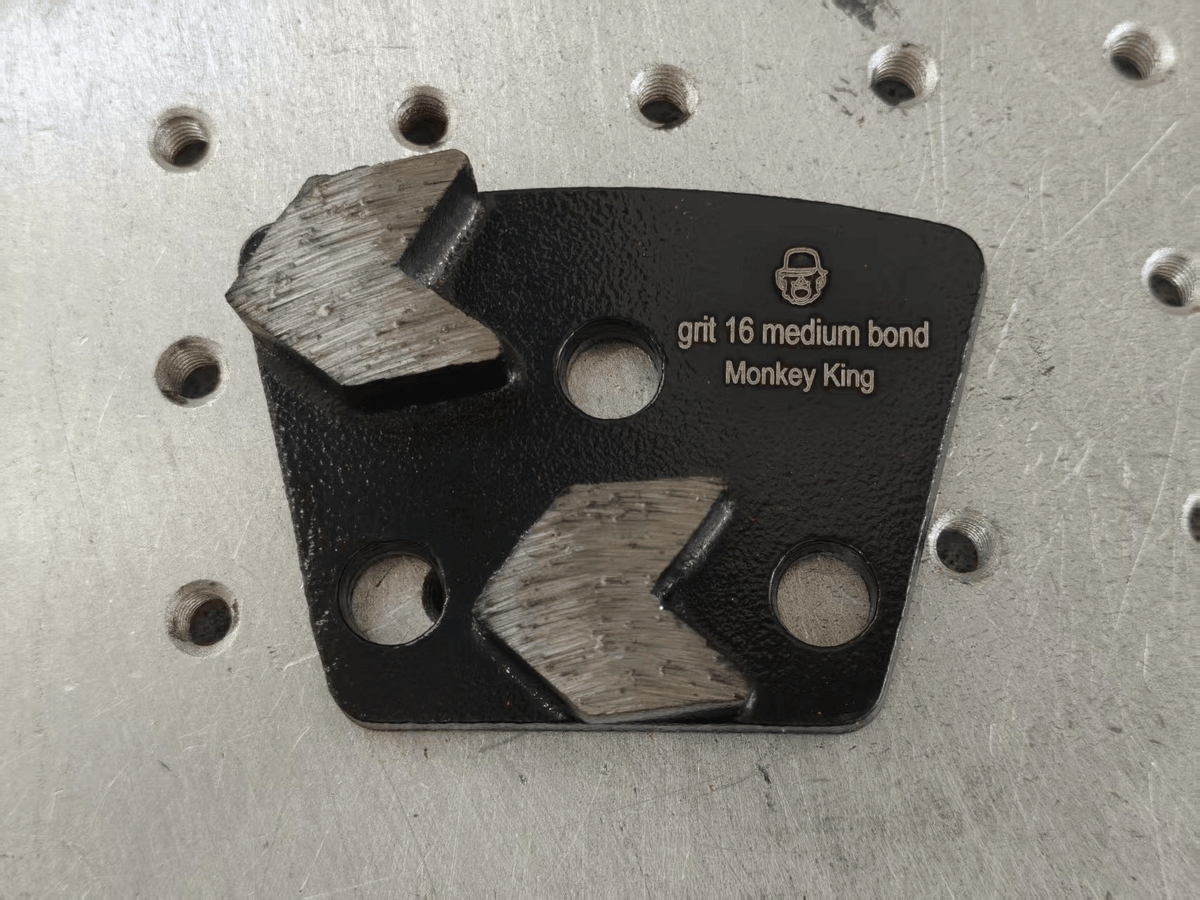Black 3-hole trapezoid metal-bond grinding tool marked 30 grit medium bond for concrete floor preparation